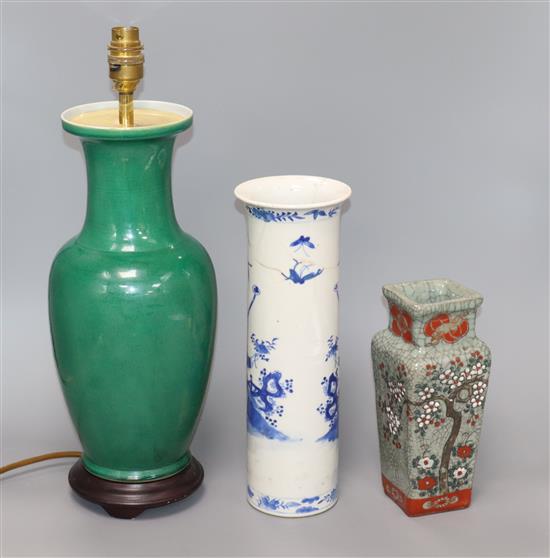 A Chinese green glazed lamp, a blue and white sleeve vase and a crackle glaze vase